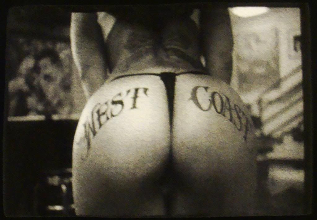 Featuring a woman with the words "West Coast" tattoed on her ass.